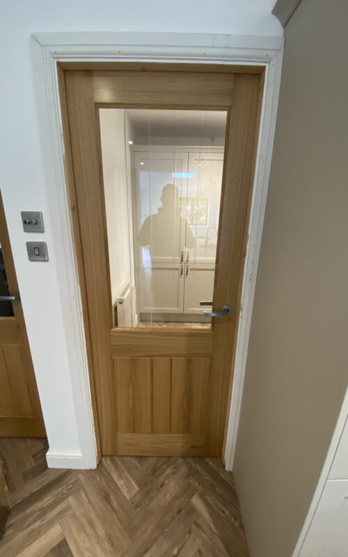 Oak internal door with glass pane.